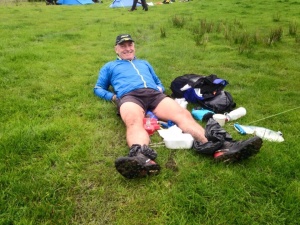 Robson rests his buggered pins at the campsite.